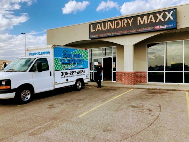 The Drain Cleaner van parked outside Laundry Maxx