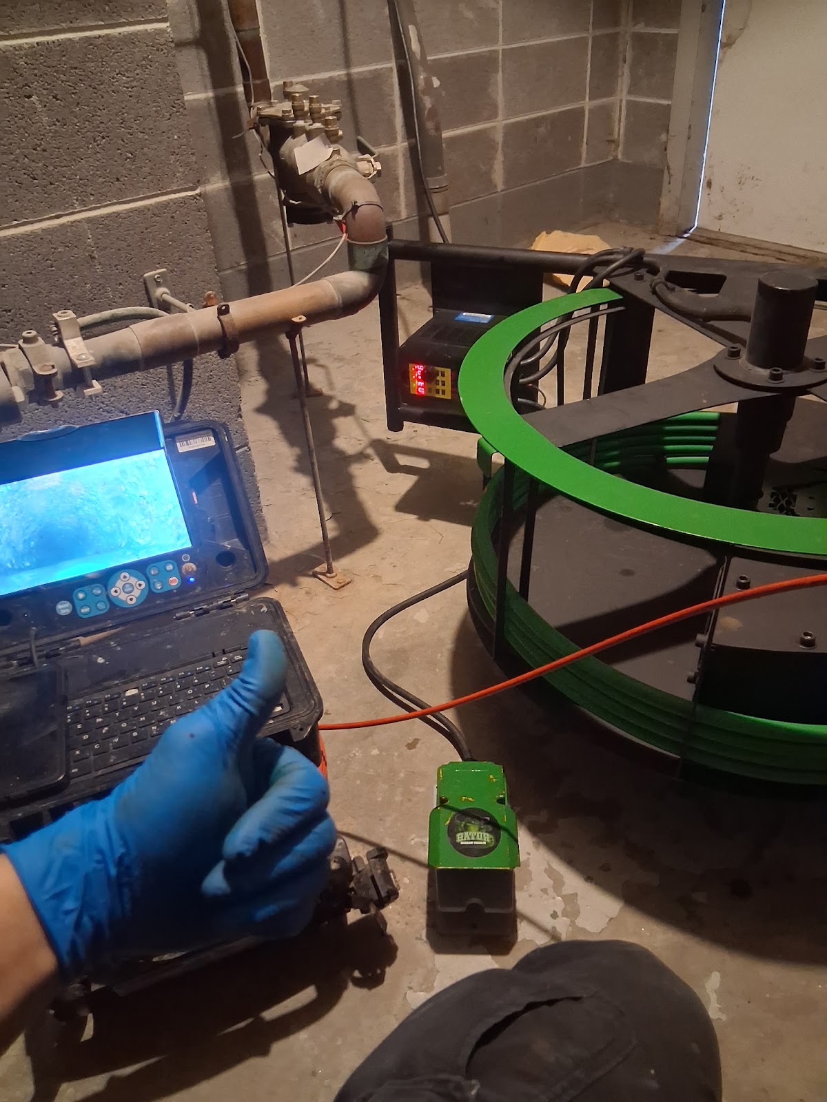 Sewer camera reel and monitor set up in a basement